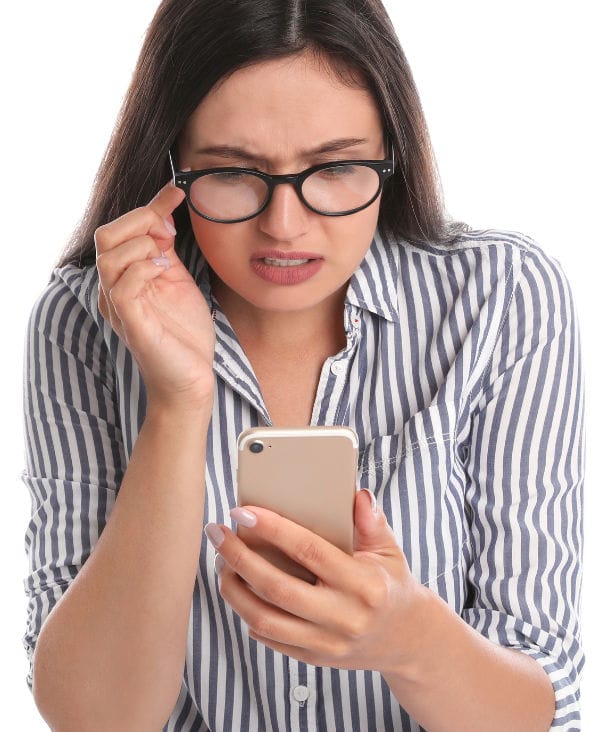 A woman with glasses looking at the phone.